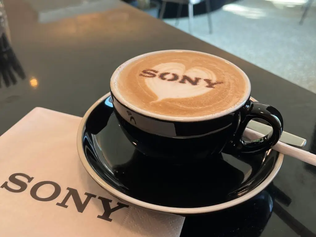 schwarze Tasse mit Cappuccino und Latte Art